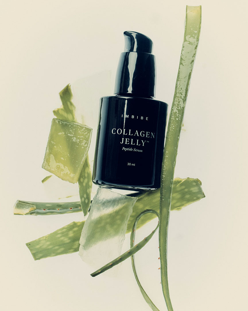 A bottle of Collagen Jelly arranged with fresh aloe vera
