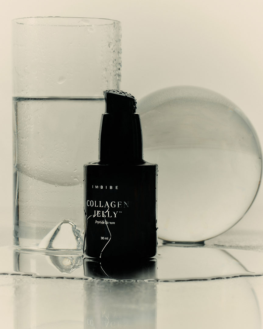 A Collagen Jelly bottle styled with glass and water droplets